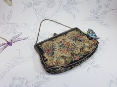 Vintage petit point tapestry evening bag, vintage needlepoint clutch bag, vintage floral tapestry evening bag This is a lovely vintage petit point evening bag dating from the mid 20th century or even slightly earlier. It has an ornate gilt metal frame and chain top handle. It measures approximately 19 cm wide and 14 cm high not including the handle. The inside is lined with a good light pink fabric with a little pocket on one side. The outside is finished with a colourful decorative floral design. The bag has some light signs of wear which I've tried to show in the photos, but is in overall good vintage condition. A fantastic vintage evening bag. Click here for more vintage bags and purses: https://www.etsy.com/uk/shop/spareoomvintage/?section_id=24996016 All of my items are packaged with Antique Tapestry Evening Bag, Vintage Embroidered Clutch For Formal Events, Needlepoint Clutch, Light Pink Fabric, Vintage Evening Bags, Chain Top, Vintage Needlepoint, Floral Tapestry, Bag Vintage