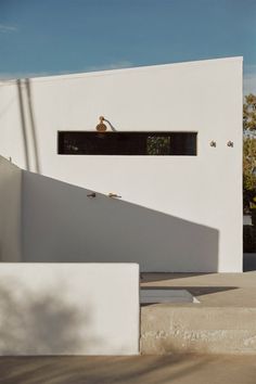 a white house with stairs leading up to it