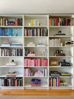 a white book shelf filled with lots of books