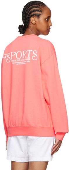 Pre-shrunk garment-dyed 11.5 oz cotton fleece sweatshirt. · Rib knit crewneck, hem, and cuffs · Logo and text printed at chest and back · Dropped shoulders Supplier color: Strawberry/White Oversized Crew Neck Sweats For Sports Season, Collegiate Oversized Sweats With Ribbed Cuffs, Oversized Collegiate Sweats With Ribbed Cuffs, Sporty Crew Hoodie For Spring, Sporty Text Print Sweatshirt For Spring, Sports Season Crew Sweater With Ribbed Cuffs, Crew Sweater With Ribbed Cuffs For Sports Season, Athleisure Crew Neck Sweatshirt With Text Print, Crew Neck Sweater With Ribbed Cuffs For Sports Season