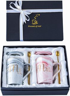 two coffee mugs are in a gift box