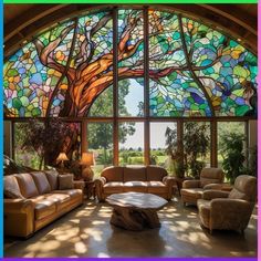 a living room filled with furniture under a large stained glass window