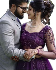 a man and woman dressed in formal wear posing for the camera together, with their hands on each other's chest