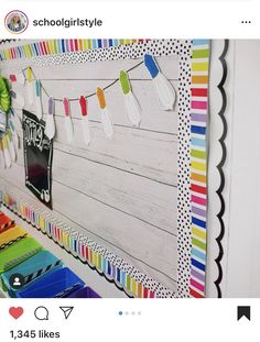 a colorful bulletin board with paper clips hanging from it's sides and colored pencils on the pegs