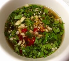 a white bowl filled with soup and vegetables