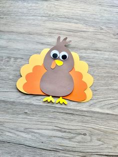 a paper turkey on a wooden table