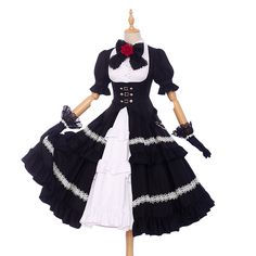 a black and white dress with red roses on the collar, sleeves, and ruffles