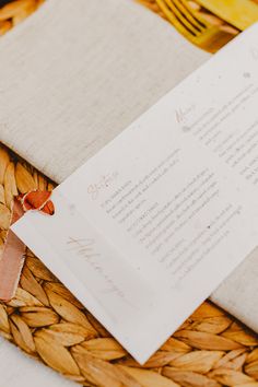 a close up of a menu on a table with napkins and bananas in the background