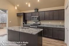 an empty kitchen with granite counter tops and dark wood cabinets, along with sliding glass doors