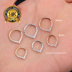 four pairs of gold and silver nose rings with clear crystal stones on each one side