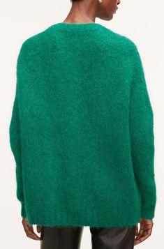 Stitched with a soft Italian brushed blend, this cozy cardigan is designed with drop shoulders for a slightly relaxed fit. Green Textured Knit Long Sleeve Cardigan, Soft Knit Green Sweater For Layering, Green Soft Knit Cardigan For Layering, Mohair Cardigan With Soft Texture, Soft Mohair Long Sleeve Cardigan, Soft Mohair Cardigan, Green Mohair Winter Cardigan, Green Cozy Outerwear For Layering, Cozy Green Outerwear For Layering