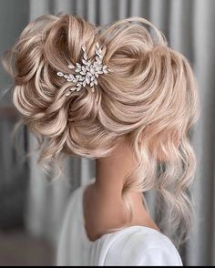 a woman with blonde hair wearing a wedding hairstyle