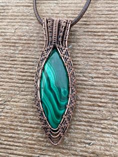 This nicely colored Malachite simple pendant was hand crafted by me with love. Made with 99% copper that has been oxidized to give it a vintage appearance. It features a nicely color patterned, green Malachite. This design is feminine and masculine so would be a great gift for a man or a woman. It is a bigger piece All my pendants come with a simple 20 inch black corded necklace. I can do custom orders on all of the designs in my shop. If you would like a different stone in a particular setting/ Spiritual Copper Necklace With Gemstone, Spiritual Copper Gemstone Necklace, Artisan Hand Wrapped Oval Pendant Necklace, Spiritual Hand Wrapped Oval Pendant Jewelry, Copper Wire Necklace With Oval Pendant For Gift, Copper Wire Necklace With Oval Pendant As Gift, Handmade Artisan Bronze Jewelry, Oval Pendant Necklace In Copper Wire As A Gift, Handmade Artisan Copper Jewelry