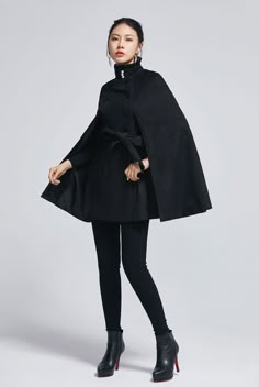 "How gorgeous is this elegant black cape with stand up collar and ruffle details. It's enough to keep you warm but keeping your hands available when needed as a winter cape, but also a perfect option when pregnant. Made from soft wool fabric, the short cape is completely lined in polyester with a tie belt waist, pockets. This is a cape coat you will wear forever. DESIGN FEATURES * 50% Wool blend, 50% fiber nylon * Polyester lining * Double Breasted * Seam pockets * Stand up collar with ruffles * Cape Coat Outfit, Short Cape Coat, Winter Cape Coat, Black Cape Coat, Cape Outfit, Belted Cape, Winter Cape, Punk Style Outfits, Cape For Women