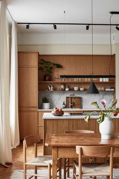 a wooden table and chairs in a room