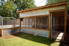 a dog kennel in the middle of a yard