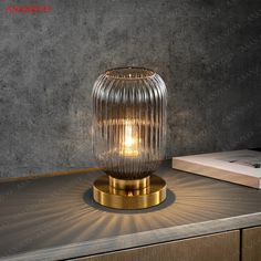 a glass table lamp sitting on top of a counter