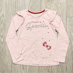 Hello Kitty Shirt (New With Tag) -Size: 8 -Color: Pink With Gold Glitter “Sparkle” And Hello Kitty -Measurements & Detailed Description: Please Refer To Pics Pet/Smoke Free Home Long Sleeve Cotton Tops With Glitter Print, Spring Long Sleeve Glitter Tops, Hello Kitty Long Sleeve Cotton Top, Long Sleeve Cotton Hello Kitty Top, Pink Cotton T-shirt With Glitter Print, Pink Glitter Print Cotton T-shirt, Casual Long Sleeve Glitter Tops, Pink Glitter Print Crew Neck Top, Pink Casual Top With Glitter Print