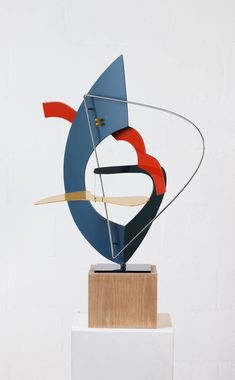 an abstract sculpture on top of a wooden block