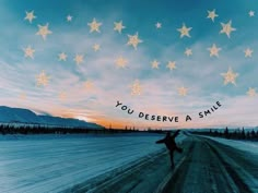 a person standing on a snow covered road with stars in the sky above them that says, you deserves a smile