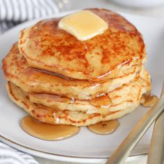 a stack of pancakes topped with butter and syrup