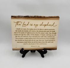 the lord is my shepherd wooden plaque with black rubber gloves on it's legs