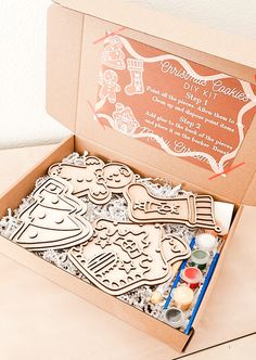 an open cardboard box with some crafting supplies in it