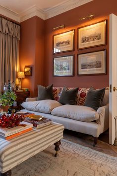 a living room filled with furniture and pictures on the wall above it's coffee table