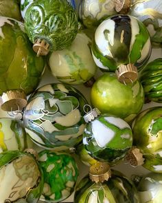 green and white glass ornaments are arranged together