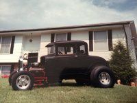 an old truck parked in front of a house