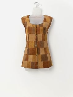 70s vintage tan patchwork suede vest. This 1970s handmade waistcoat in tan features a stunning patchwork pattern, a square neck and a snap button closure. Made from a mid-weight butter soft suede. Our recommended size: Medium Label says: No size label Condition: Good*. Small marks on front and back. Please see last images (not colour accurate) Material: No care label, confident it is suede Measurements in inches: Pit to pit: 19 Shoulders: 16 Front length: 27 Back length: 26 Hem: 22 *Imperfection Retro Patchwork Vest For Fall, Fitted Patchwork Vest For Fall, Vintage Brown Vest With Button Closure, Brown Patchwork Vest For Fall, Suede Vest, Vintage Patchwork, Patchwork Patterns, Vest Outfits, 70s Vintage