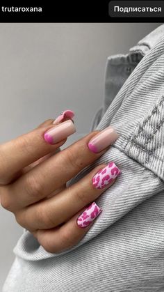 a woman's hand with pink and white nail polish