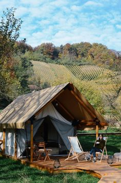 a tent set up in the middle of a field