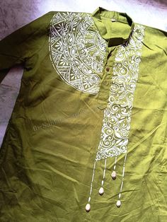 a green shirt with white designs on it