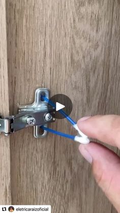 a person is opening the door with blue handles and white plastic handle to open it