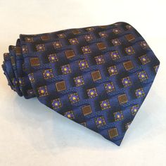 Robert Talbott for Nordstrom Silk Necktie Navy blue, with gold and yellow, in a geometric pattern. Imported silk. Hand sewn. Made in the USA. 4" wide 59" long Professional Blue Suit And Tie Accessories For Business, Blue Standard Tie For Formal Occasions, Classic Blue Neckwear For Business, Classic Blue Business Neckwear, Blue Semi-formal Necktie, Professional Blue Suit And Tie Accessories For Work, Blue Professional Suit And Tie Accessories For Workwear, Blue Semi-formal Standard Tie, Blue Semi-formal Neckwear