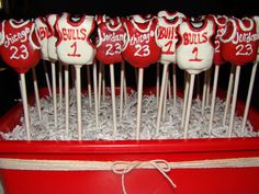 red and white lollipops with numbers on them are sitting in a box