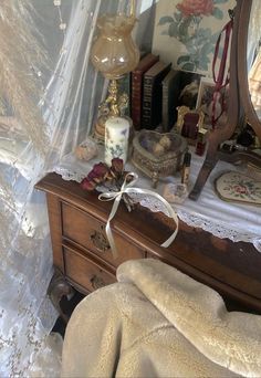 a bedroom with a dresser, mirror and other items on the table in front of it