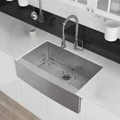 a stainless steel sink in a white kitchen