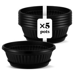 two black plastic pots with white labels on them