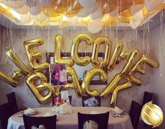 balloons that spell out the word bloop are hanging above a table