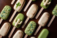 green and white desserts are arranged on sticks