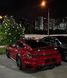 two red sports cars parked next to each other