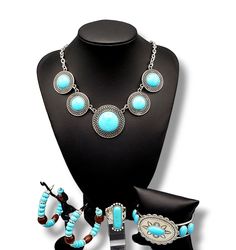 This trendy yet earthy Jewelry set comes with a necklace and complimentary earrings, upgraded earrings, a cuff bracelet, and a ring with a stretchy back.Necklace - "Circle The Wagons": Blue stones, pressed into round frames made of concentric rows of open circles, create a dramatically rustic statement as they link across the collar. Features an adjustable clasp closure. Includes one pair of matching earrings. Upgraded earrings - "​Definitely Down-To-Earth": An earthy collection of blue stone be Adjustable Costume Jewelry Sets With Round Shape, Nickel-free Turquoise Circle Jewelry, Blue Metal Jewelry, Turquoise Round Metal Jewelry, Southwestern Style Metal Jewelry For Gifts, Southwestern Style Metal Jewelry As Gift, Southwestern Style Metal Jewelry Gift, Necklace Circle, Earthy Jewelry