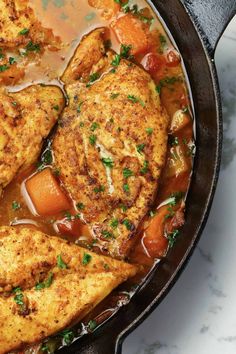 chicken stew in a skillet with carrots and parsley