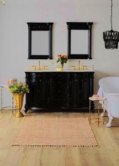 a bathroom with two sinks and a tub