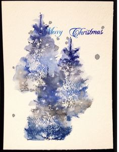 a christmas card with watercolor trees on it