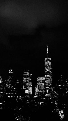 black and white photograph of city skyline at night