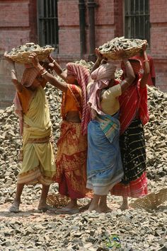 three women carrying baskets on their heads