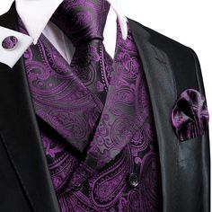 a purple paisley tie and black suit jacket